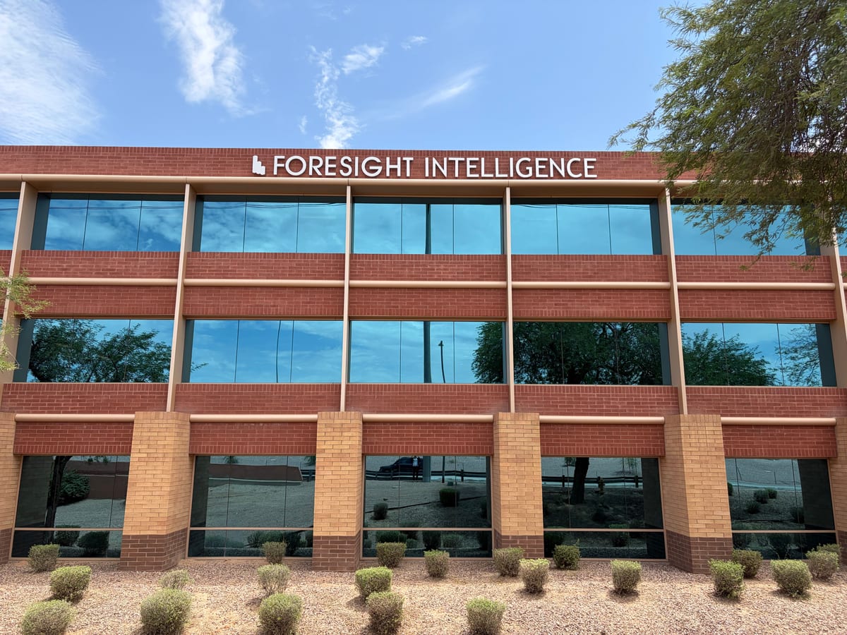 Foresight Intelligence headquarters — three-story red brick office building with tinted windows, Scottsdale, Arizona